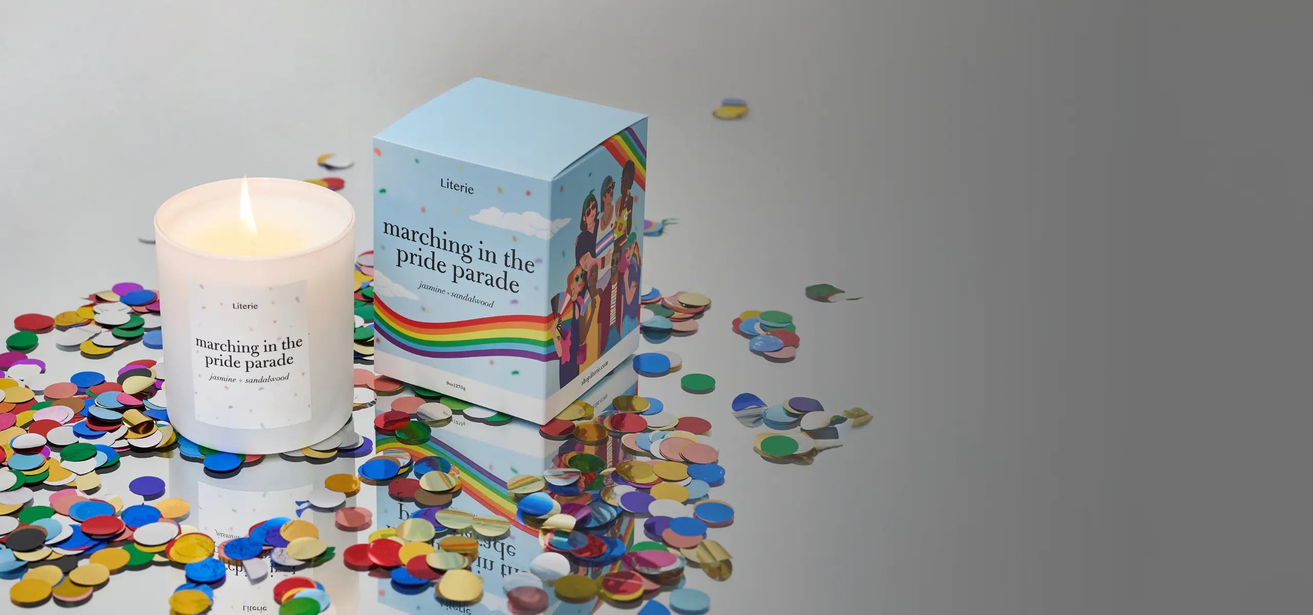 Marching in the pride parade candle and packaging with rainbow design on a gray background