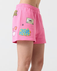 Person wearing pink Clueless by Samii Ryan shorts with colorful designs on a white background