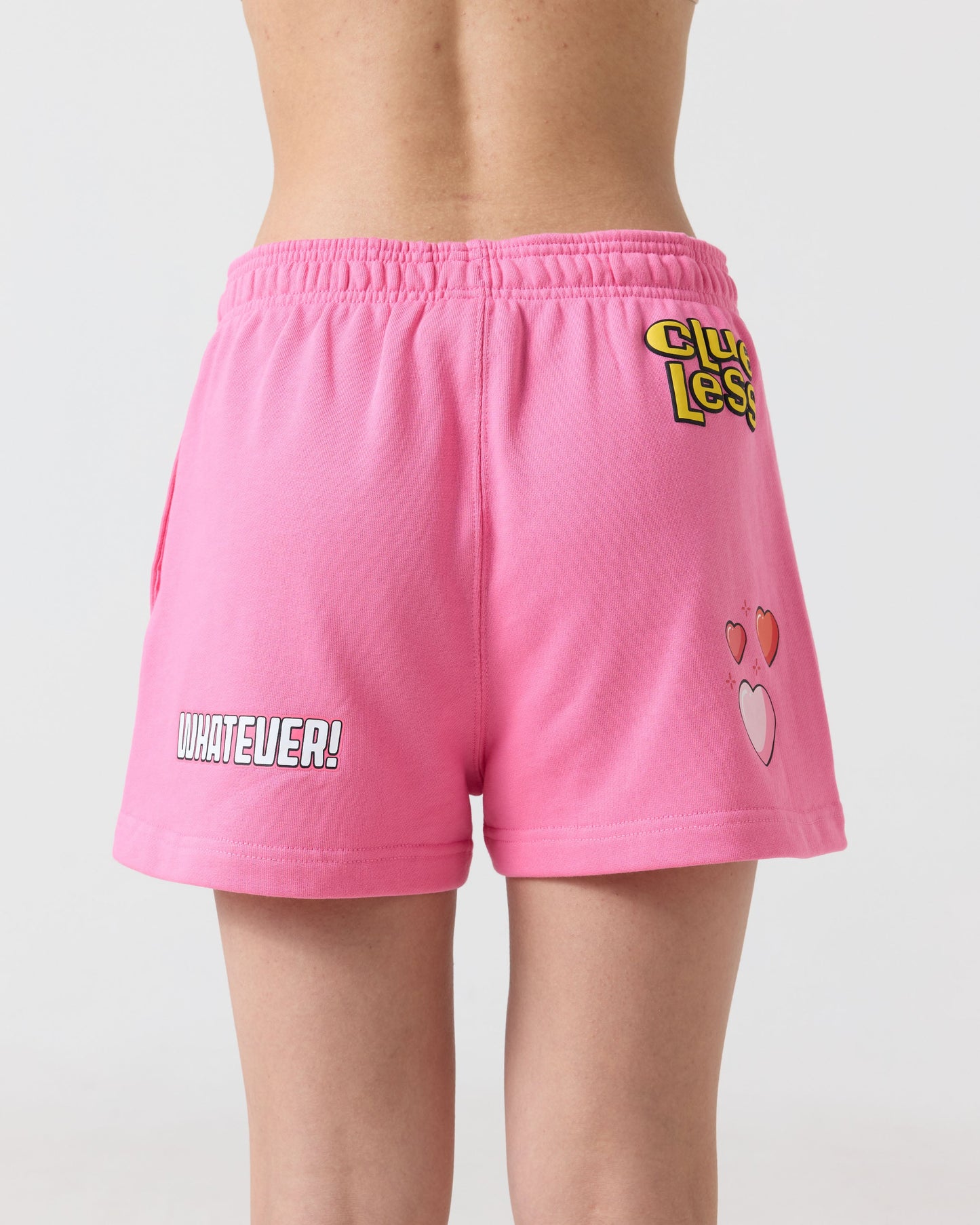 Pink shorts with text and graphics on a plain background