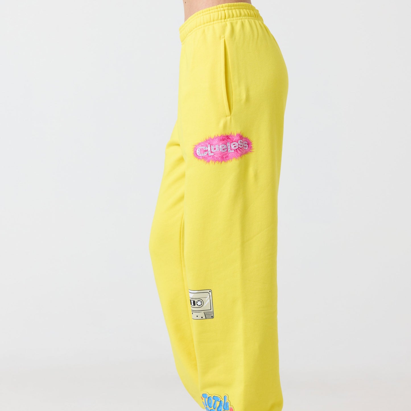 Yellow Clueless sweatpants with logos on a white background