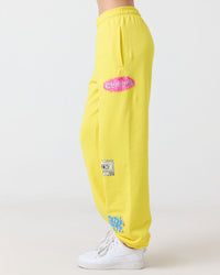 Yellow Clueless sweatpants with logos on a white background