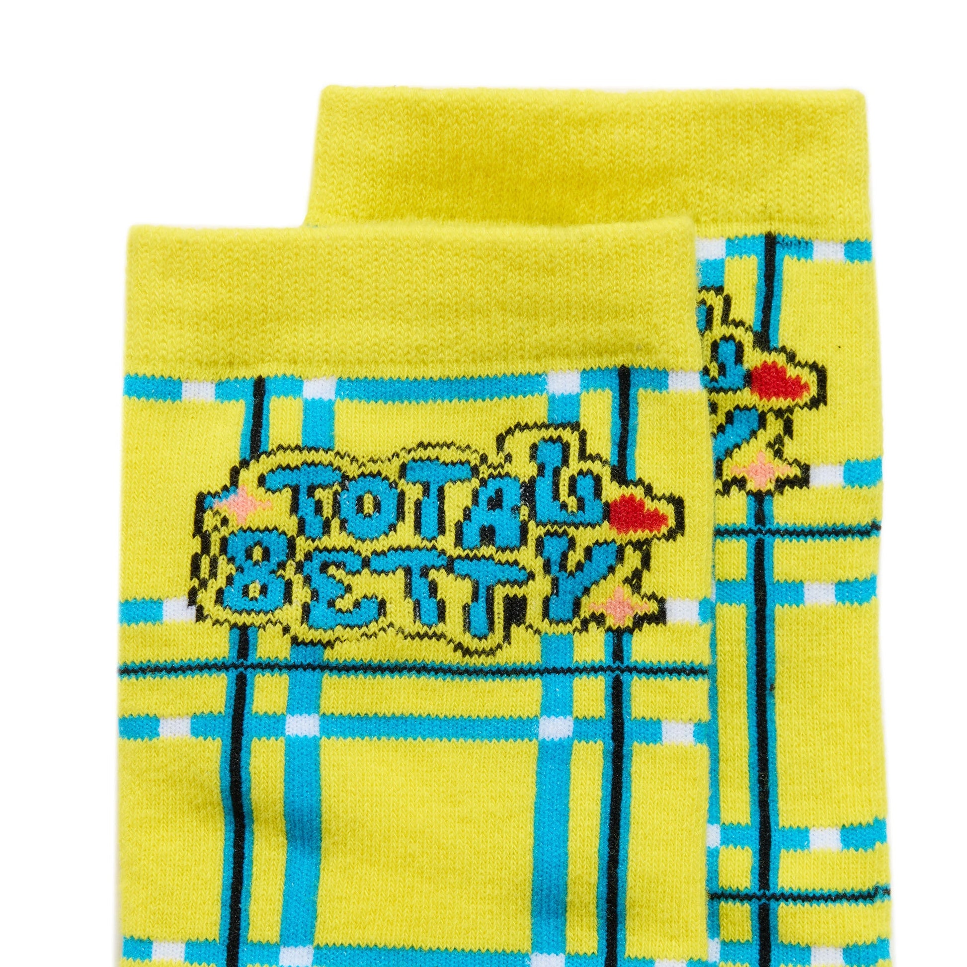 Yellow Cluless socks with plaid pattern and 'Total Betty' text on a white background