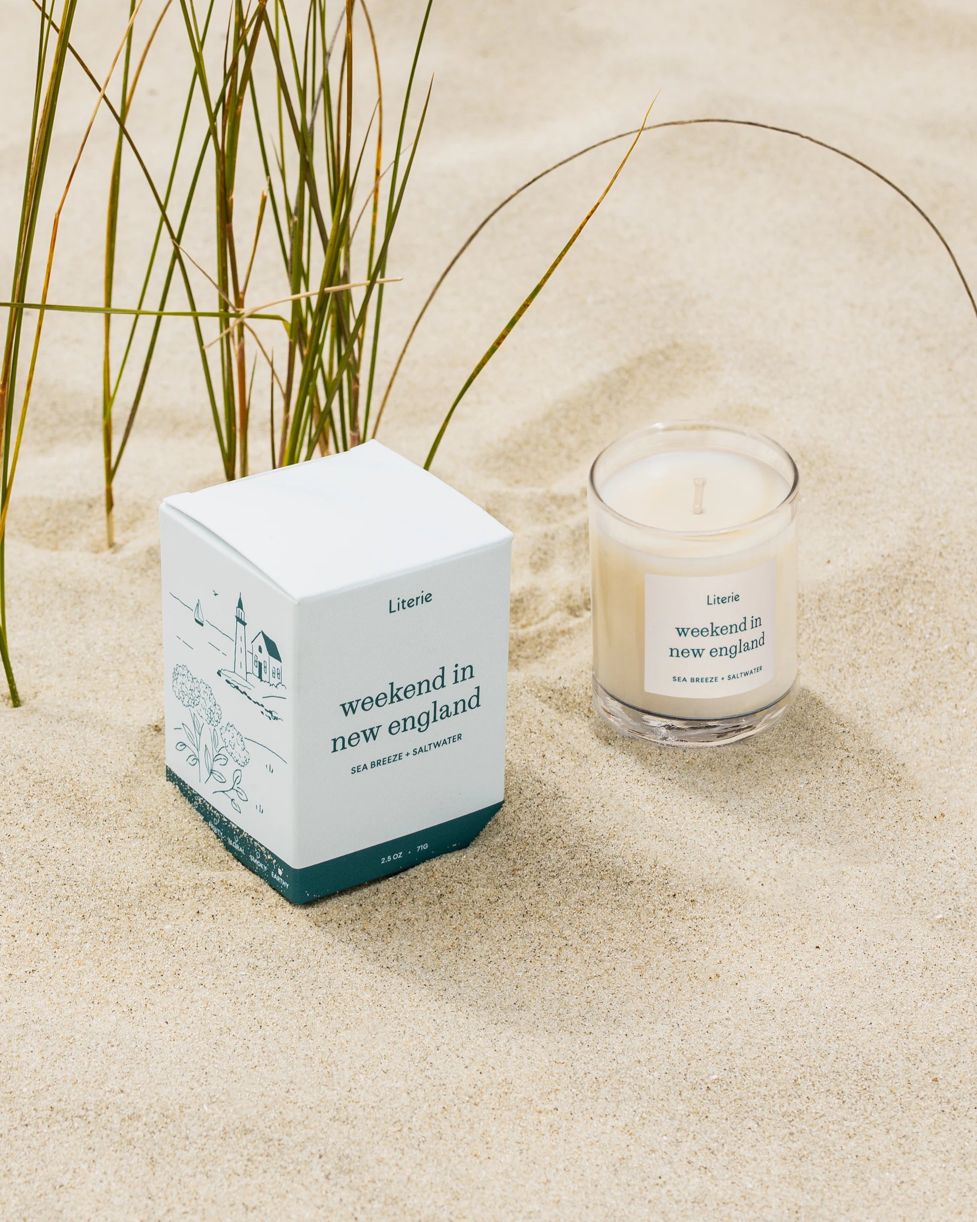 Weekend In New England little candle and box on a sandy beach.