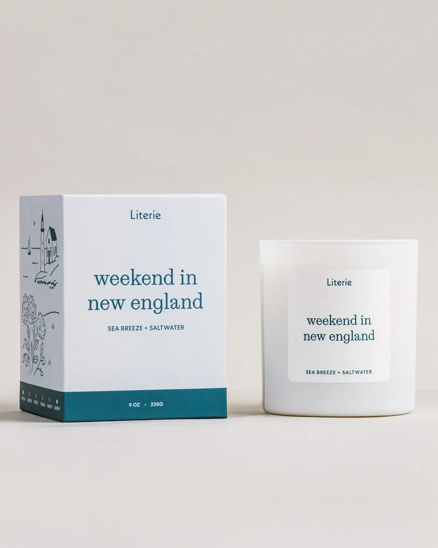 Candle and packaging labeled 'weekend in new england' by Literie on a neutral background