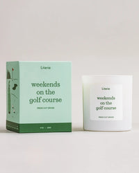 Candle and packaging of 'weekends on the golf course' by Literie on a light background
