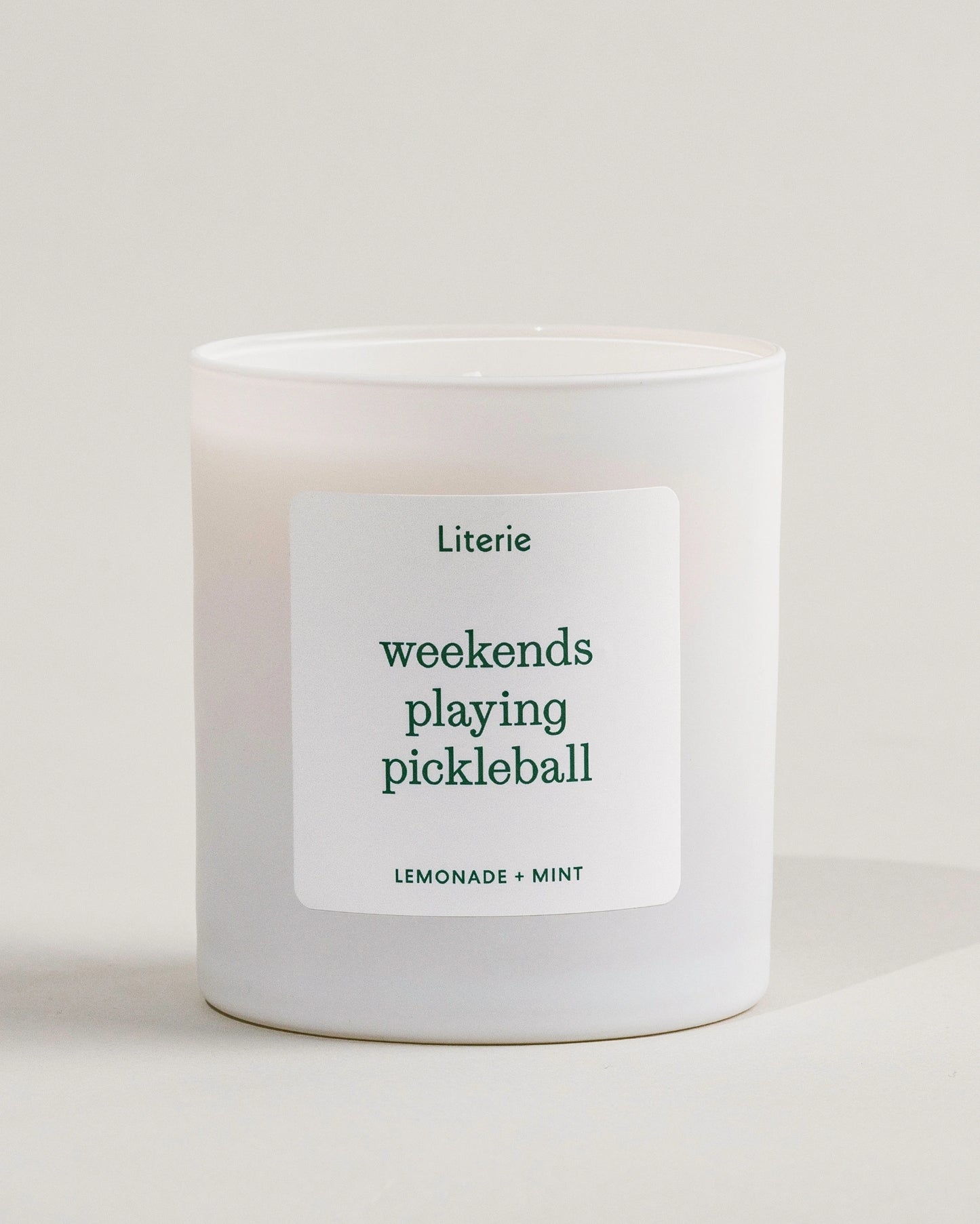 'weekends playing pickleball' candle by Literie on a white background