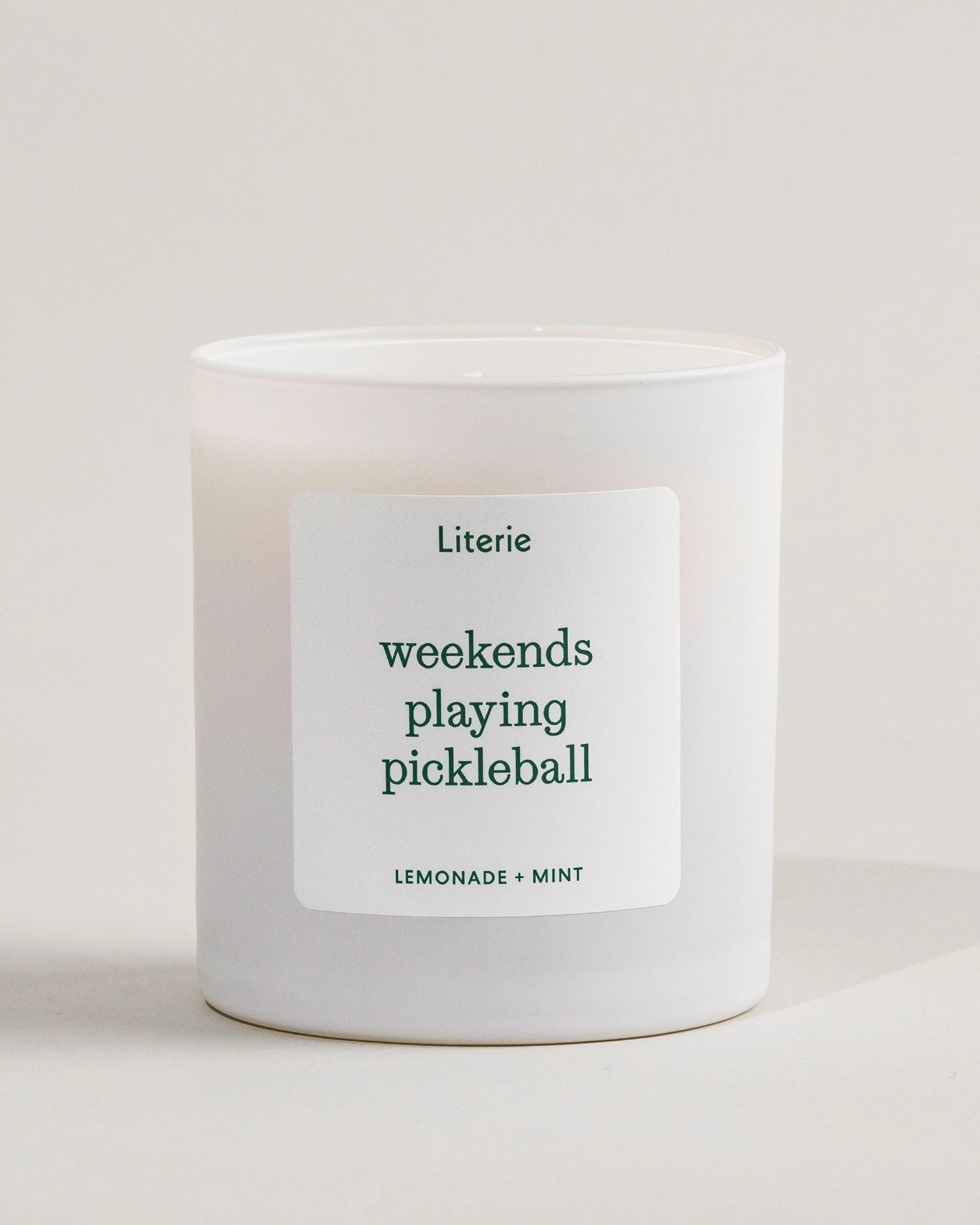'weekends playing pickleball' candle by Literie on a white background