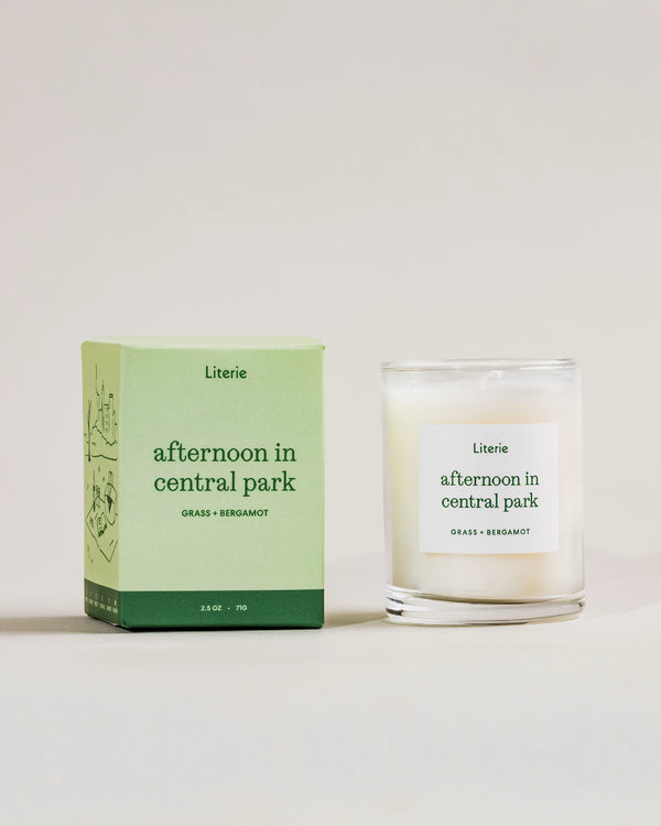 Literie candle and packaging labeled 'afternoon in central park' on a light background