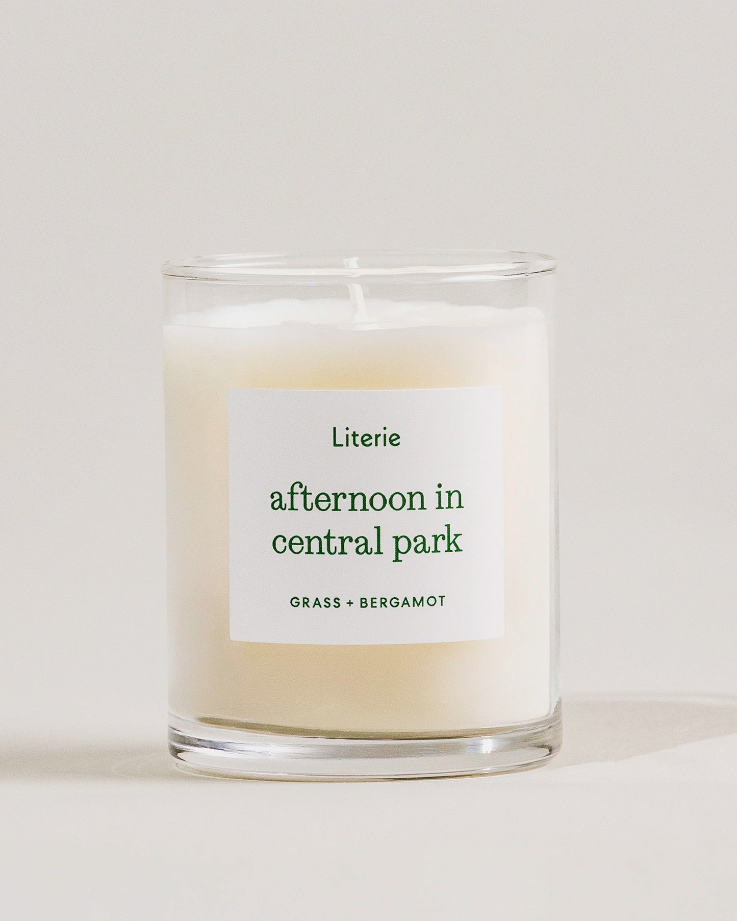 Candle labeled 'afternoon in central park' by Literie on a light background
