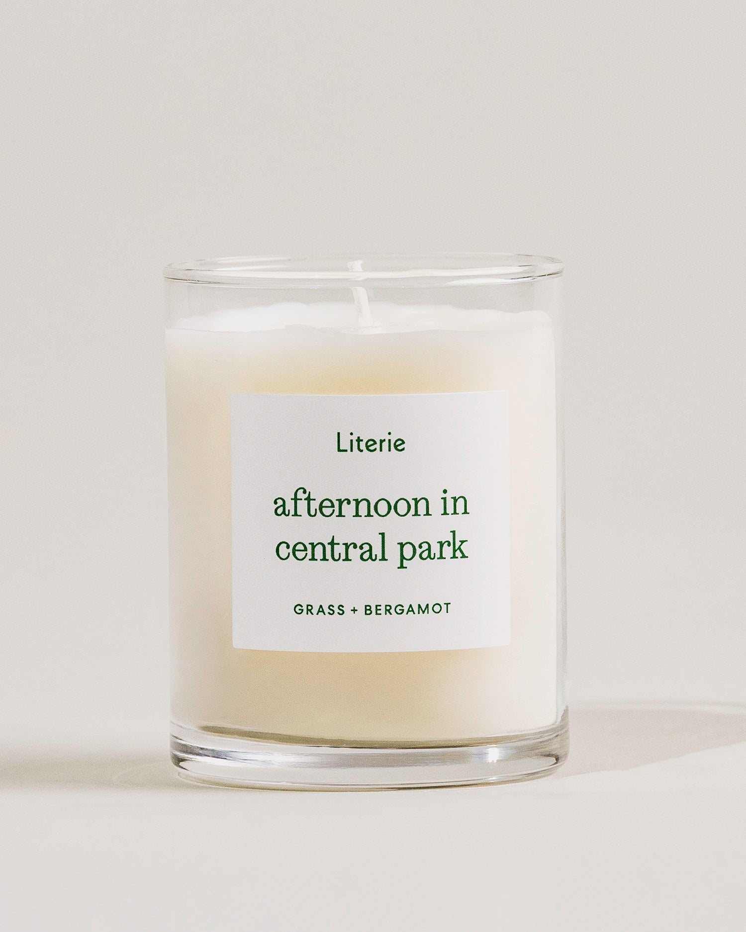 Candle labeled 'afternoon in central park' by Literie on a light background