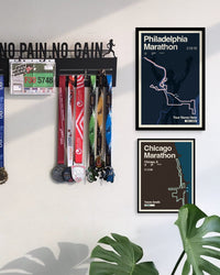 Wall with marathon-themed decor including framed posters and medals