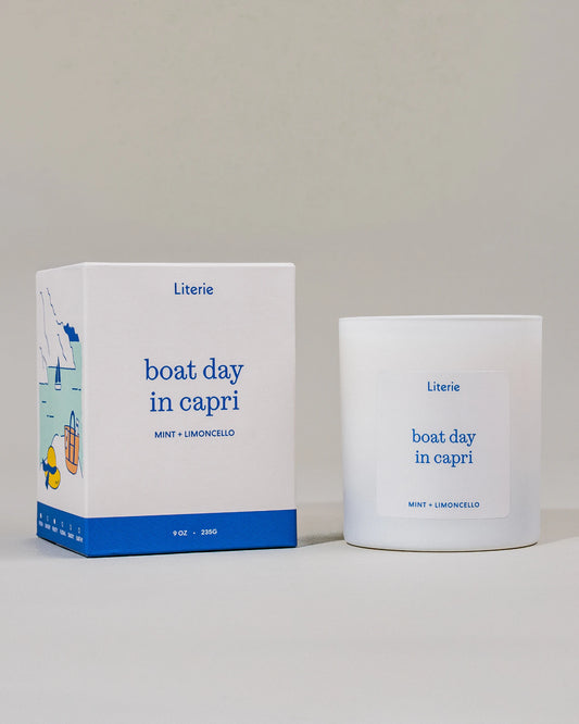 Candle and packaging of 'boat day in capri' by Literie on a light gray background