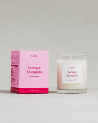 "Bodega Bouquets" little candle and box on a grey background.