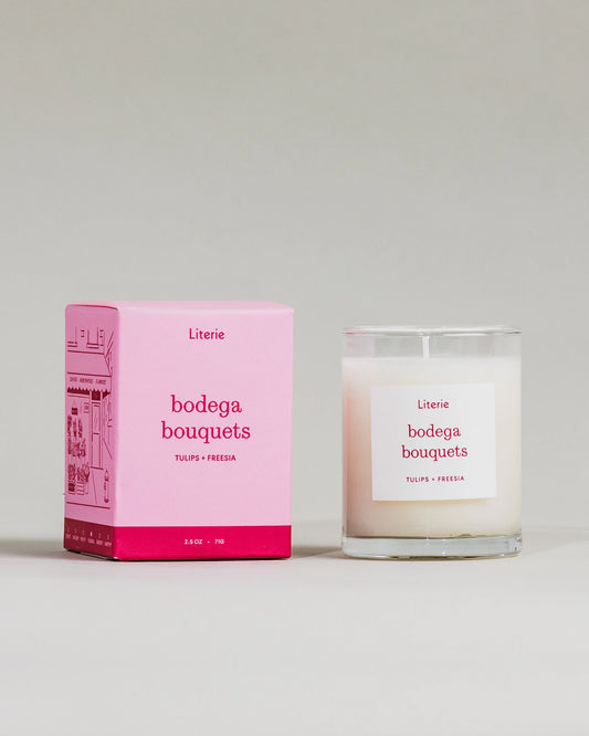 "Bodega Bouquets" little candle and box on a grey background.