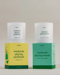 'weekends playing pickleball' and 'weekends playing tennis' candles and boxes on a neutral background.