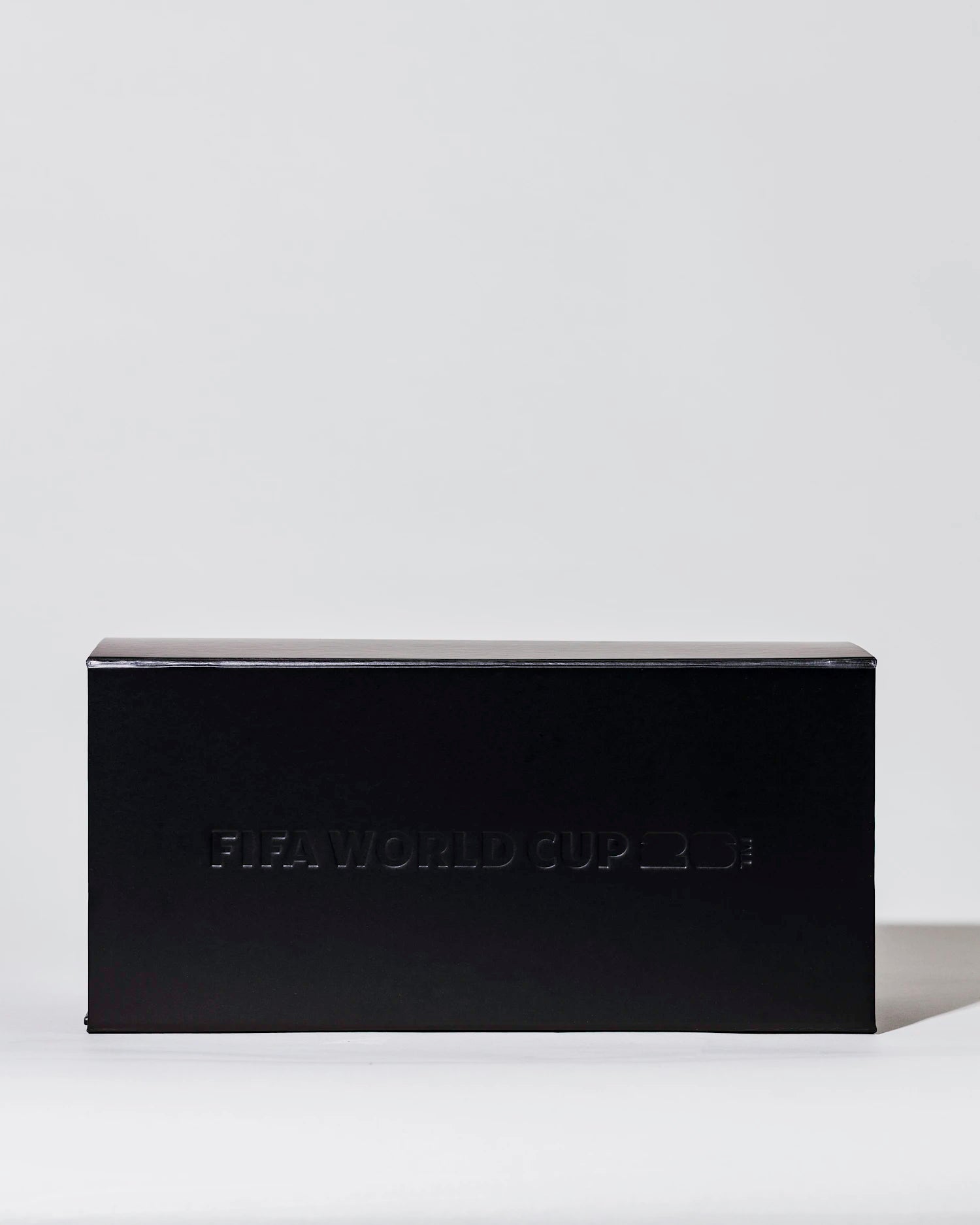 Black rectangular candle gift box with 'FIFA WORLD CUP 26' branding on a light gray background