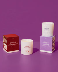 partners playing canasta candle an calling for mahjong candle on a purple background.