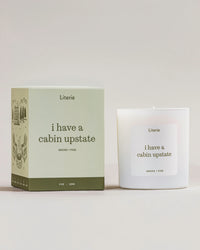 Literie candle and packaging with 'i have a cabin upstate' text on a white background