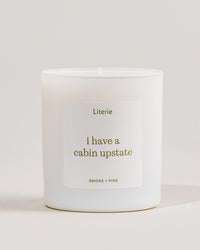 White 'i have a cabin upstate'c andle with a label on a light gray background