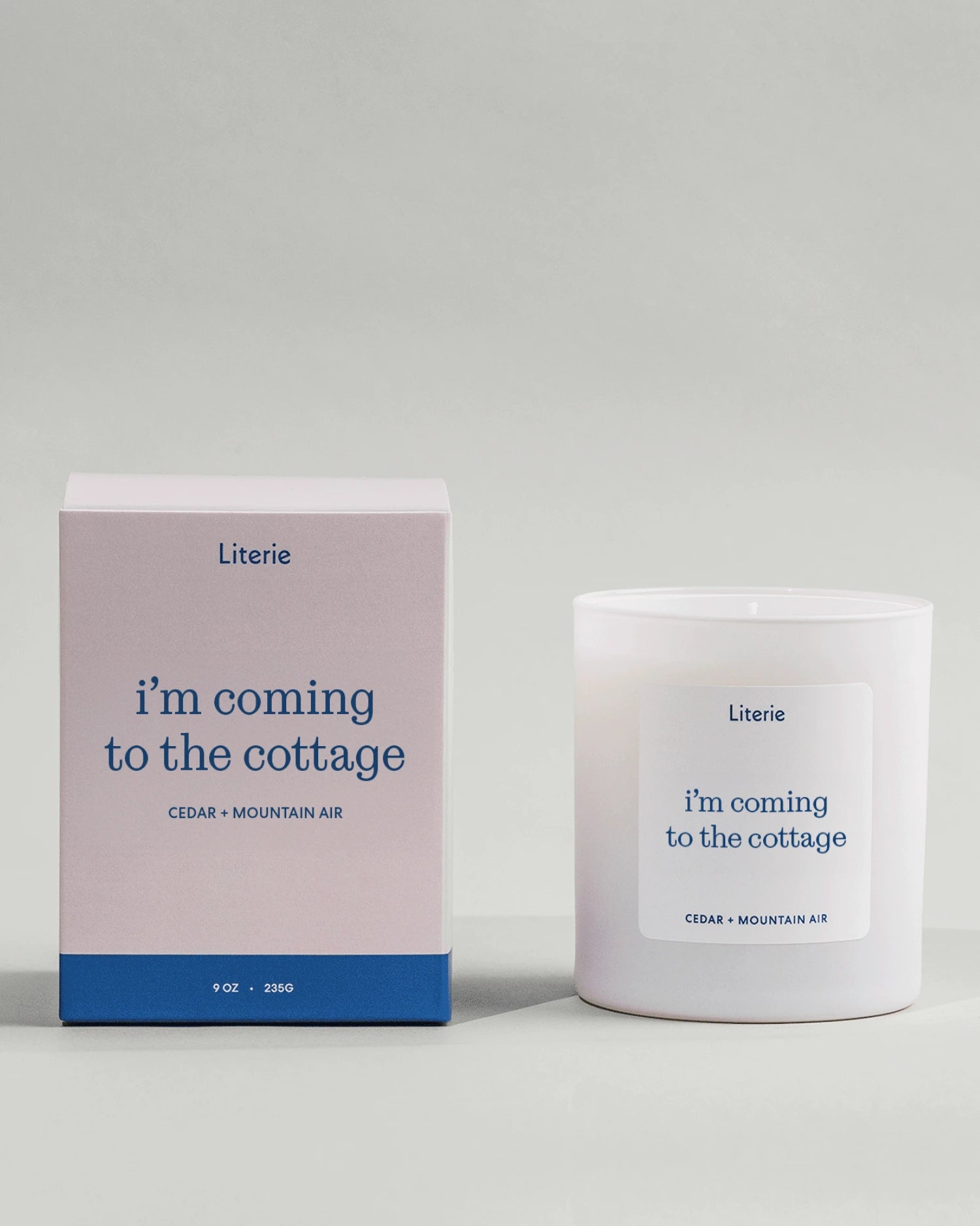 Heated Rivalry inspired candle called 'i'm coming to the cottage' with box on light grey background.