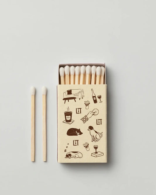 Literie matchbox with illustrations and matches on a light gray background