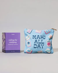 Blue pouch with 'MAHJ ALL DAY' text and purple candle  labeled 'calling for mahjong' on a light gray background