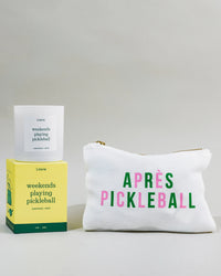 'weekends playing pickleball' candle on top of box with pickleball pouch.