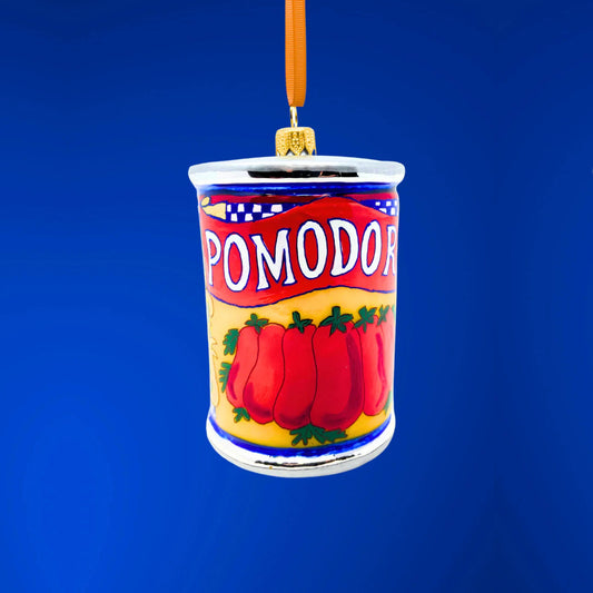Decorative tomato can christmas ornament with 'Pomodor' label on a blue background.