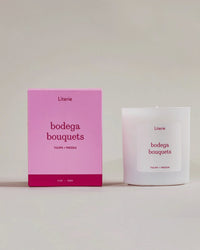 'bodega bouquets' candle box spinning with the candle next to it.