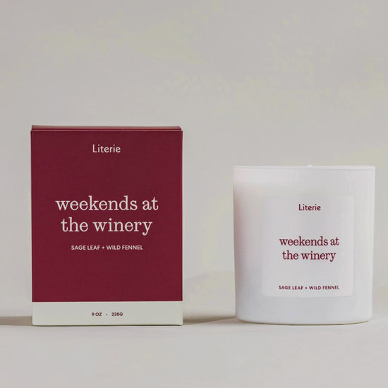 Weekends at the winery candle box turning with candle still next to it on a grey background.