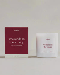 Weekends at the winery candle box turning with candle still next to it on a grey background.
