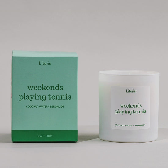 Weekends Playing Tennis candle box spinning next to the candle.