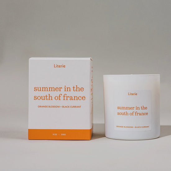 'summer in the south of france' candle and packaging on rotating on a grey background.