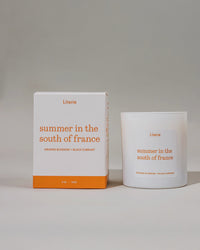 'summer in the south of france' candle and packaging on rotating on a grey background.