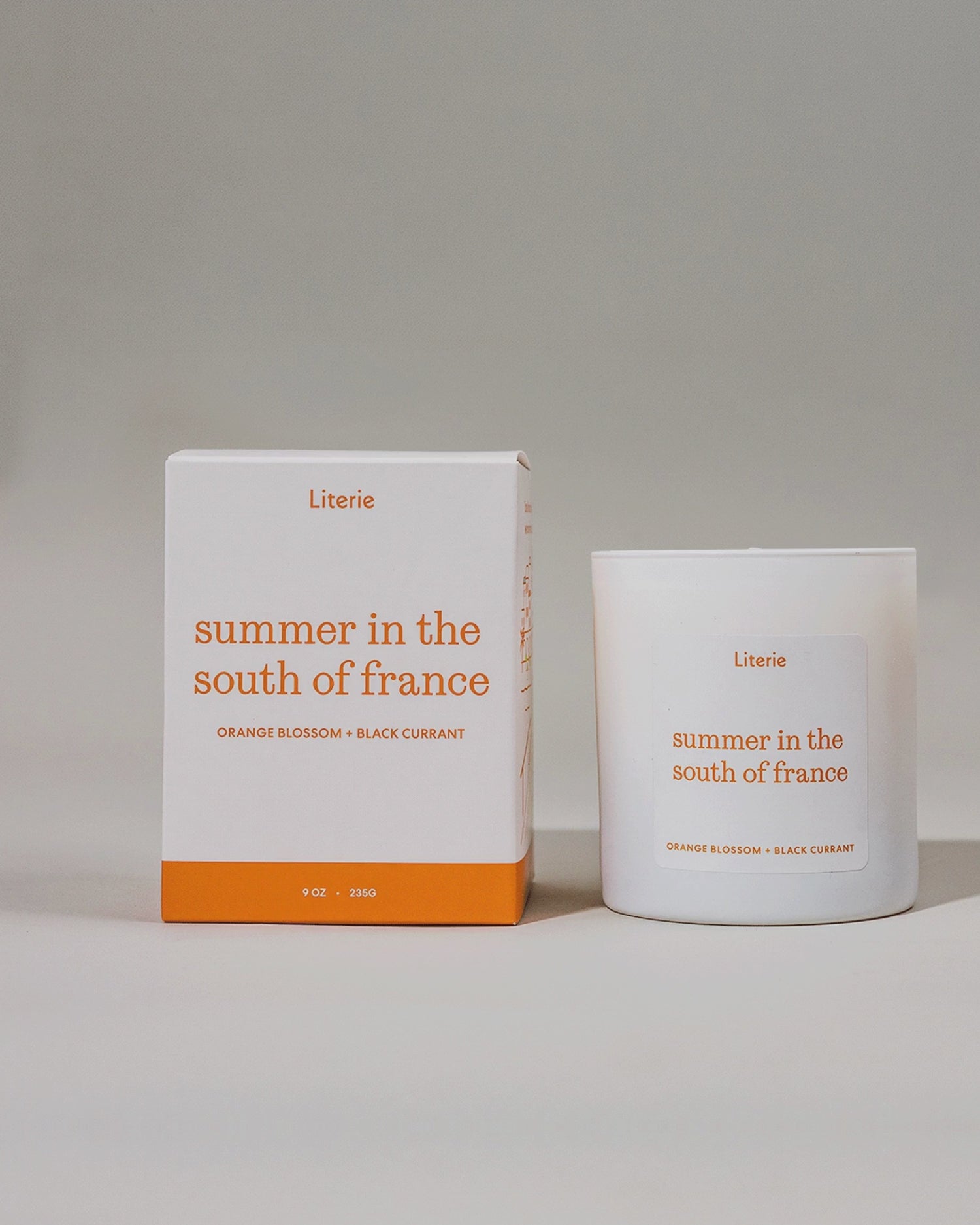 'summer in the south of france' candle and packaging on rotating on a grey background.