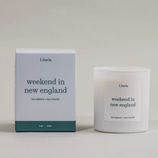 Weekend In New England candle box spinning next to the candle.