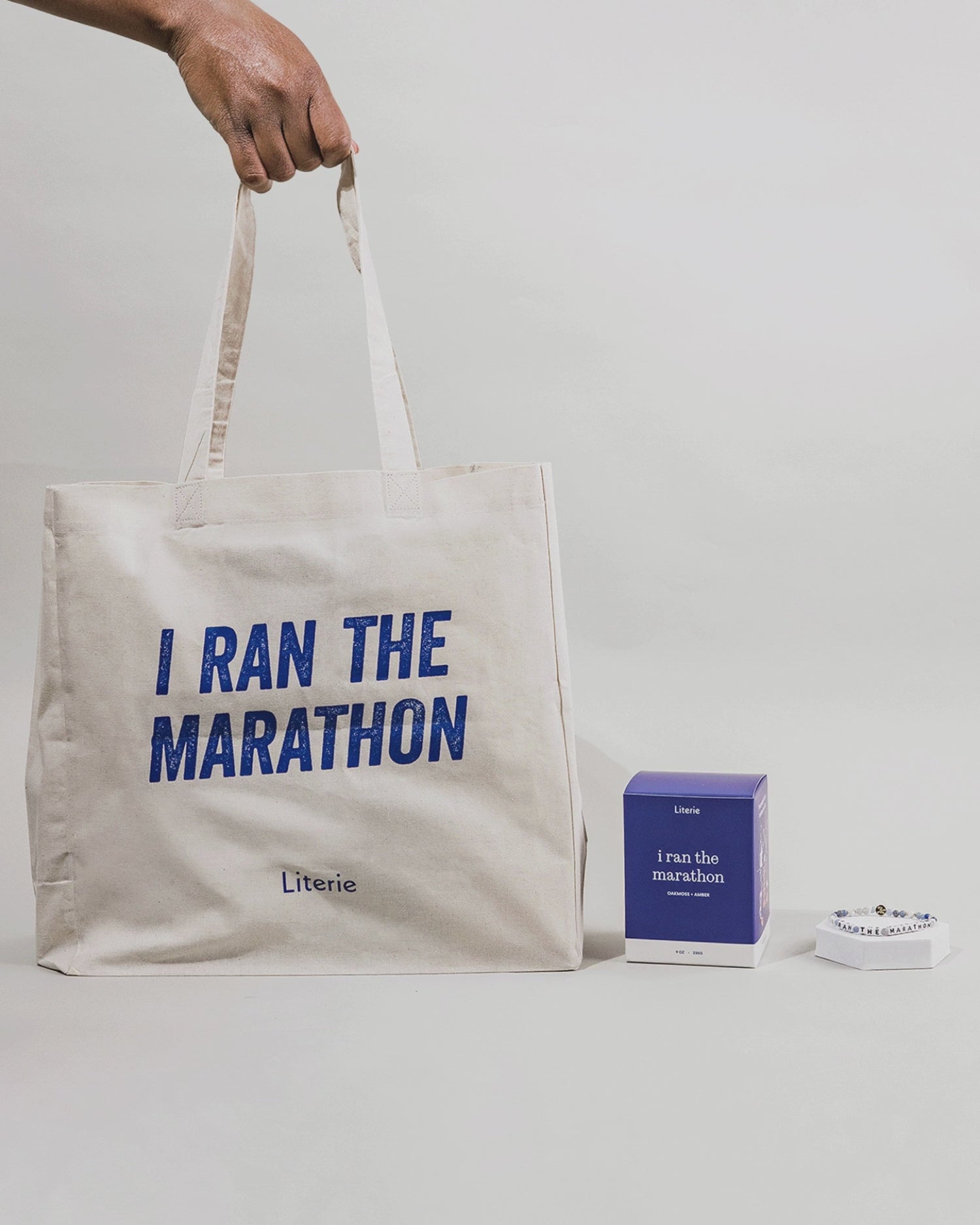I Ran The Marathon tote bag and bracelet staying still with the candle box rotating.
