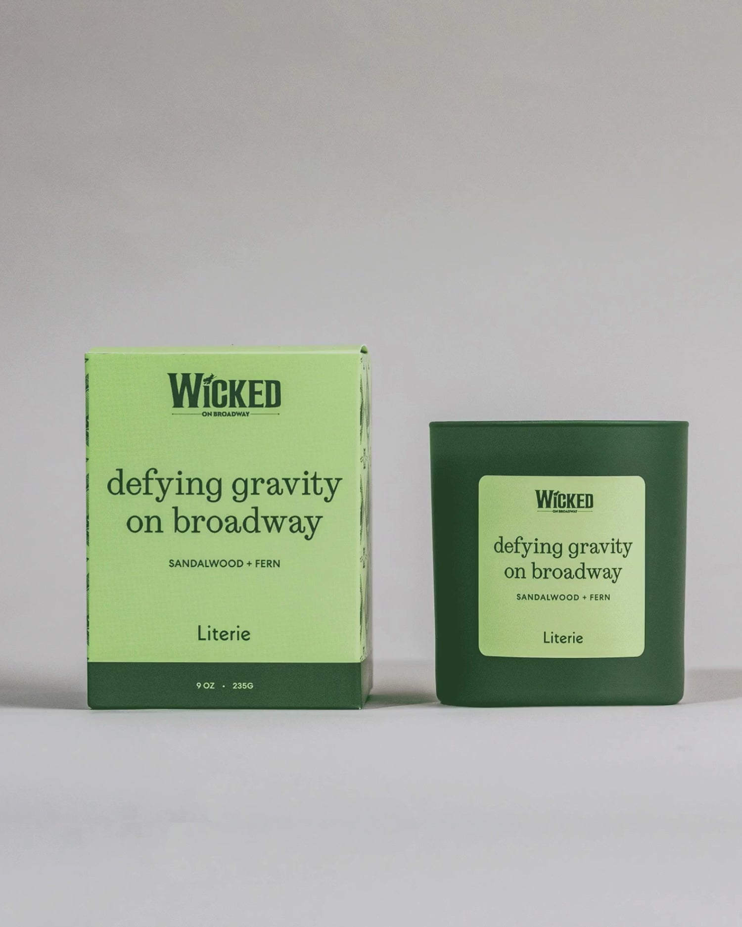 Wicked on Broadway candle named 'defying gravity on broadway' next to packaging spinning.
