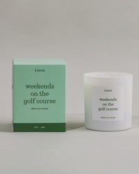 Weekends On The Golf Course candle box spinning next to the candle.