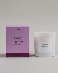 'a cozy night in' candle by Liteire new to it's packaging that is turning.