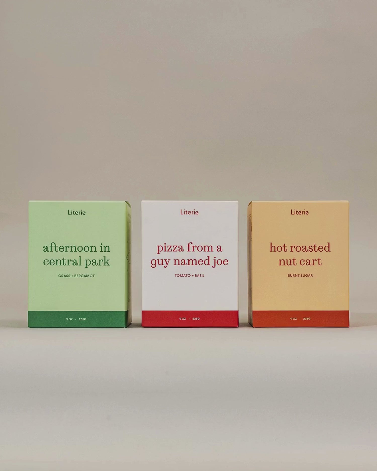 Literie's "I Love NY" candle trio spinning to show of product packaging illustrations on a grey background. 