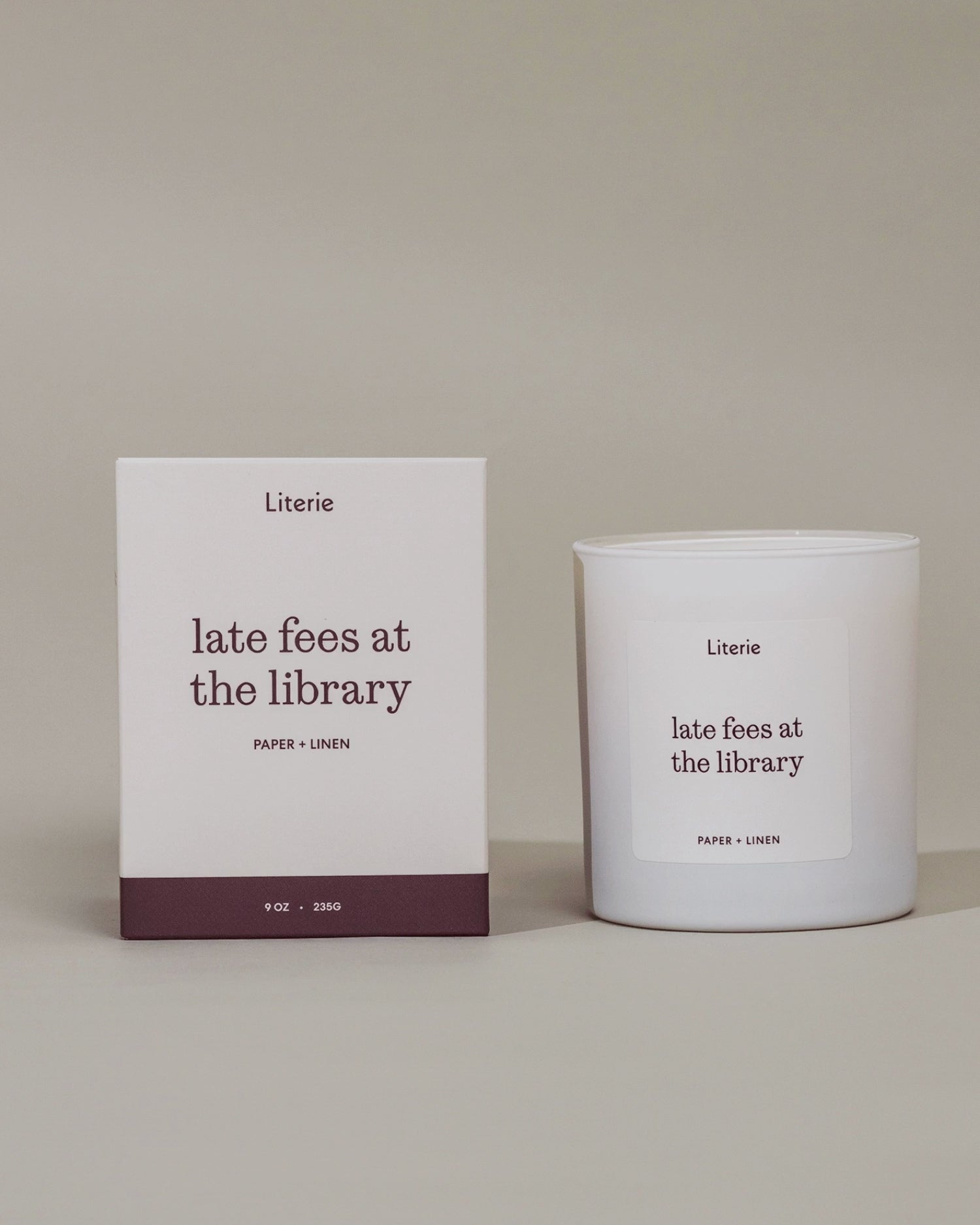 "late fees at the library"candle next to it's box that's rotating to view illustrations on the box. 