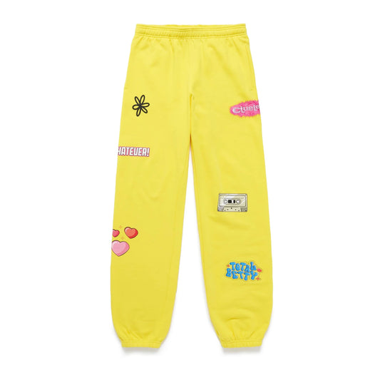 Yellow Clueless sweatpants by Samii Ryan with various patches.