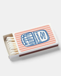 Matchbox with striped design and logo on a white background