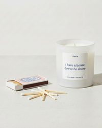 Candle with sardine matches on a light background