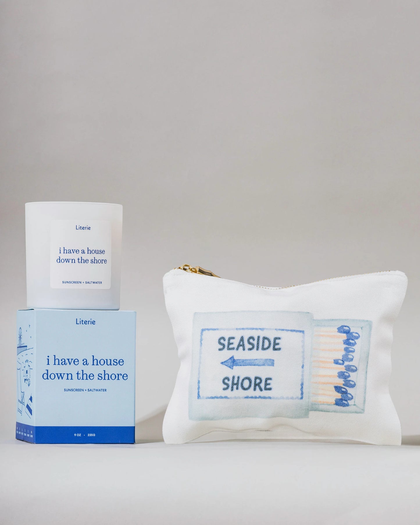'I have a house down the shore' candle, box, and pouch with 'Seaside Shore' text on a gray background.