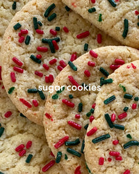 Pile of warm sugar cookies with green and red sprinkles.