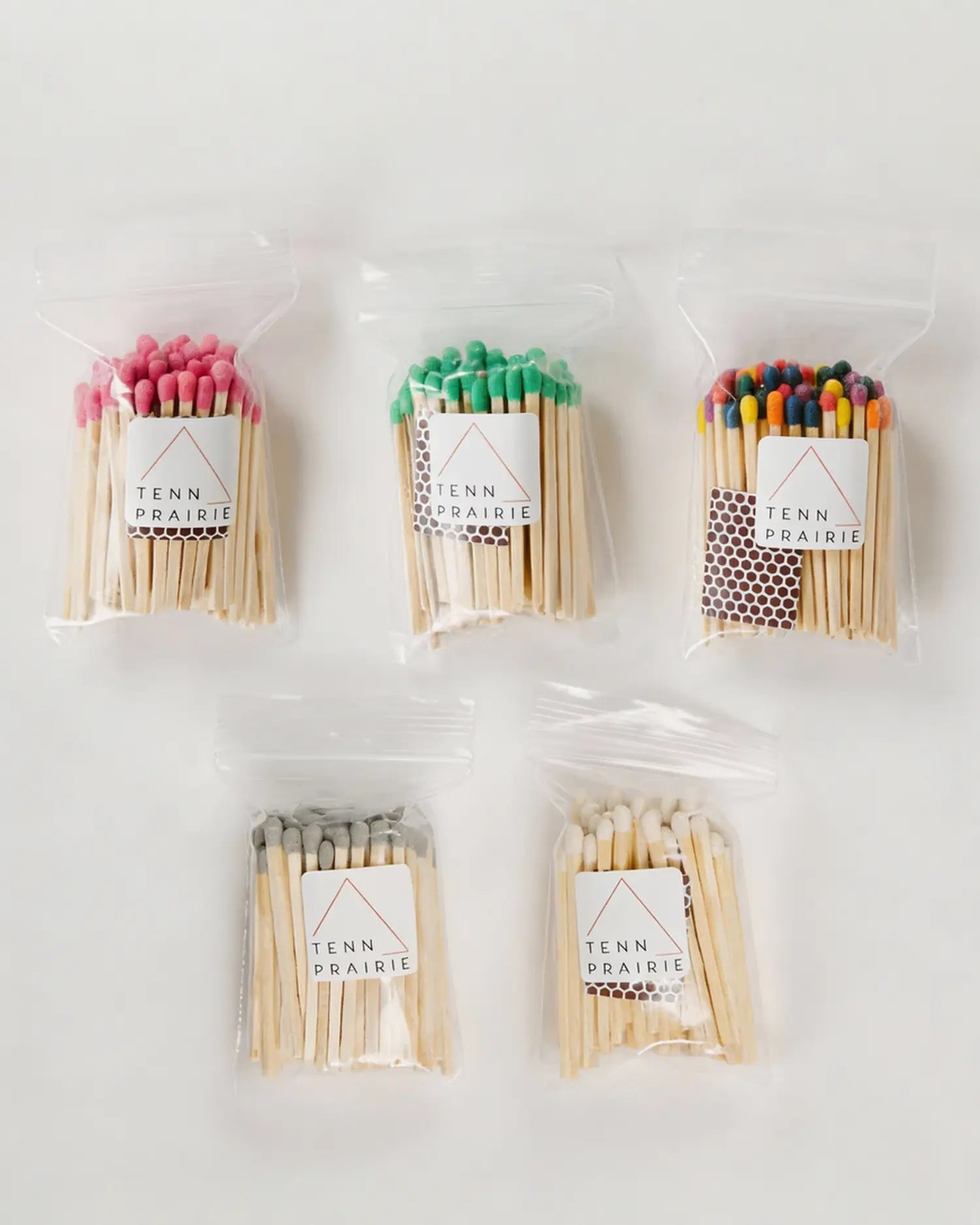 Five packages of matches with colorful heads on a white background