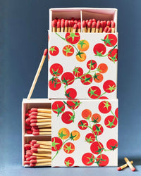Matches in a box with tomato design on a blue background