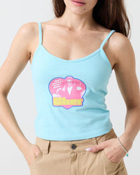 Woman wearing a light blue Cher from Clueless tank top with a colorful graphic design on a plain background